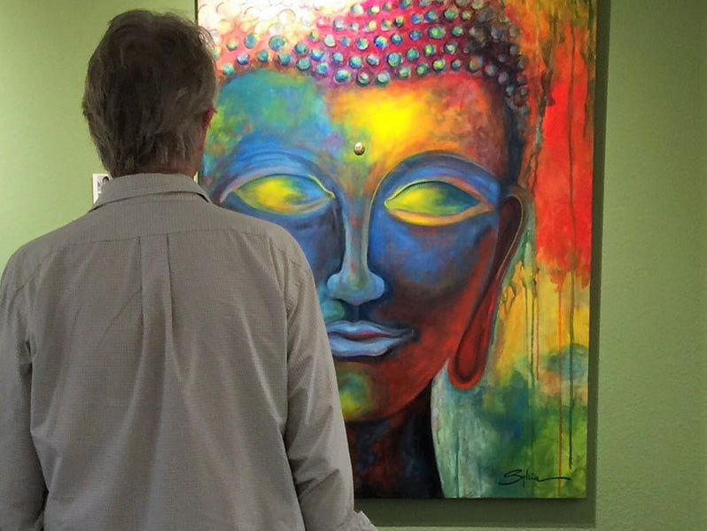 An art buyer viewing a piece in the Grotto Gallery